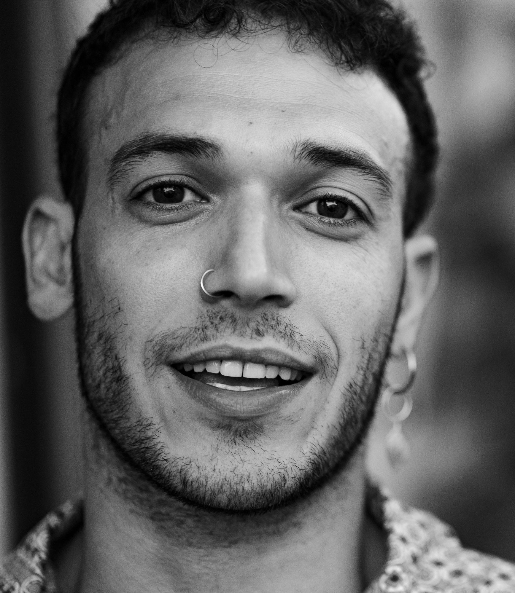 Black and white close-up portrait of Alexandros smiling